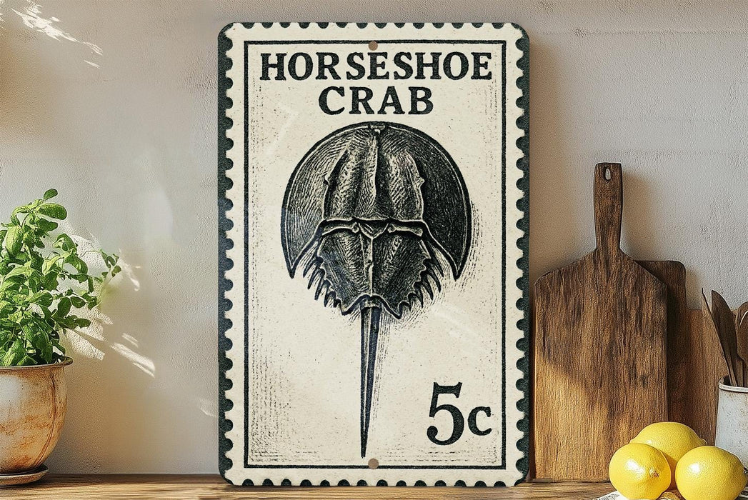 A metal sign with a black and white illustration of a horseshoe crab, mounted on a wall next to a wooden cutting board and a potted plant.
