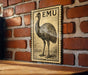 a large emu stamp on a brick wall.