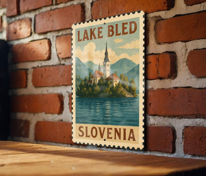 A vintage-style metal sign with the text "LAKELI BLED SLOVENIA" and an illustration of a church on a lake, mounted on a brick wall.