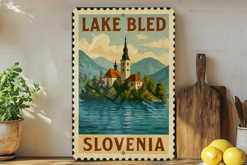 A vintage-style metal sign depicting Lake Bled in Slovenia, with a church spire and mountains in the background.
