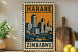 A vintage-style metal sign with the text "HARARE ZIMBABWE" displayed prominently, featuring an illustration of a city skyline. The sign is placed on a wooden surface, with a potted plant, a wooden cutting board, and some lemons nearby.