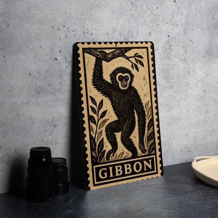 a framed print of a monkey, with the word "GIBBON" printed below the illustration.