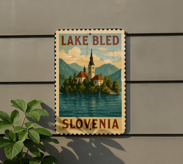 A vintage-style sign depicting Lake Bled, a famous landmark in Slovenia, with a church spire and mountains in the background.