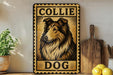A framed metal sign with a collage of a collie dog image, placed on a shelf next to a wooden cutting board and some lemons.