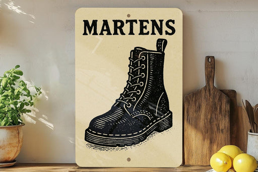 a wooden sign with a black and white illustration of a black boot, placed on a wooden surface next to a wooden cutting board and a potted plant.