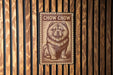 a chow chow dog, a large and fluffy breed of dog, depicted in a wooden frame.