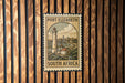 A vintage-style postage stamp from Port Elizabeth, South Africa, featuring a lighthouse and a coastal town.