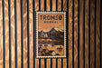 A vintage postage stamp featuring a scenic image of a bridge and houses, with the text "TROMSO NORWAY" prominently displayed.