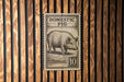 a pig stamp on a wooden wall.