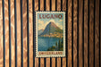 A vintage postage stamp from Switzerland featuring a mountain landscape with a town below.