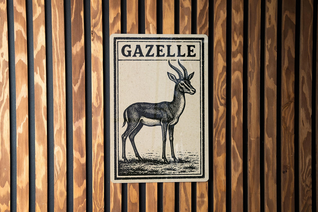 a sign with the name "Gazelle" on it, which is mounted on a wooden wall.