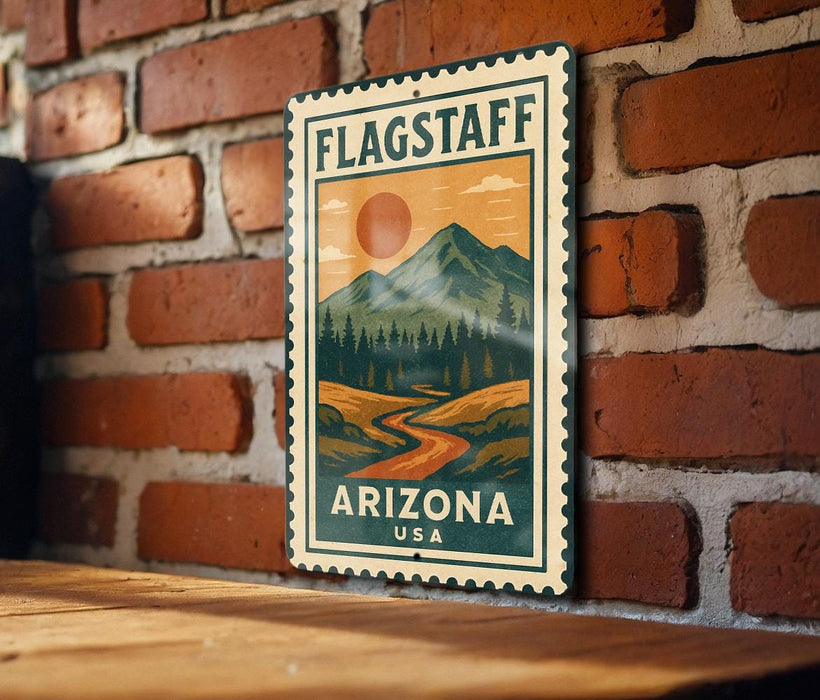 A vintage-style metal sign with a mountain landscape and a sun in the sky, mounted on a brick wall.