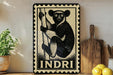 a framed illustration of a lemur, a type of primate, on a wooden shelf.