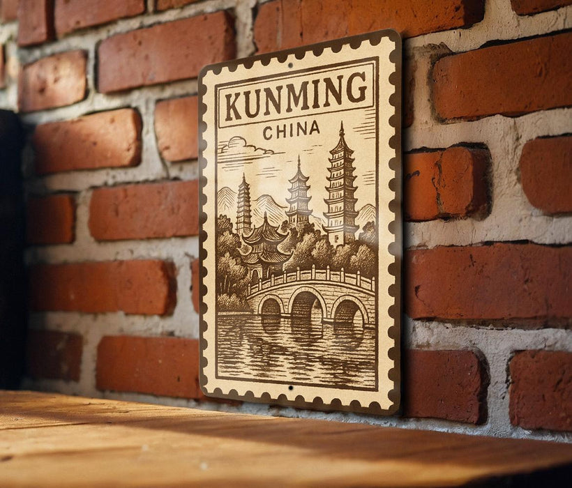 A decorative metal sign with a traditional Chinese temple illustration and a bridge, mounted on a brick wall.