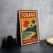 A vintage-style stamp or postcard with a tropical beach scene and palm trees, featuring the word "TOBAGO" prominently displayed.