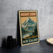 A vintage-style metal sign with the text "MOUNT COOK NEW ZEALAND" and an illustration of a mountain landscape.