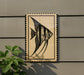 a framed picture of a fish, specifically an angelfish, displayed on a wall.