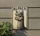 a sign with an illustration of an alpaca on it, mounted on a wall.