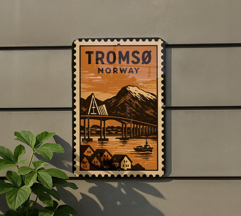 A vintage-style poster of the Tromsø-Norway bridge, featuring a mountain landscape and a small boat, is displayed on a wall.