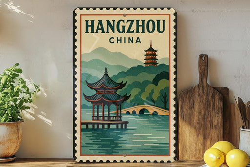 A vintage-style poster of a pagoda and a bridge in Hangzhou, China, displayed on a wall next to a wooden cutting board and some potted plants.