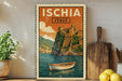 a vintage-style poster of Italy, with a boat on the water and a castle on a cliff in the background. The poster is framed and displayed on a wall, surrounded by various kitchen utensils and a potted plant.
