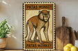 A metal sign with a monkey illustration and the text "Patas Monkey" is displayed on a shelf next to a wooden cutting board and a potted plant.