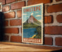 A vintage-style travel poster for Ometepe, Nicaragua, featuring a mountain landscape with a lake and palm trees.