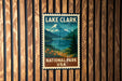 A vintage-style postage stamp featuring Lake Clark National Park in the USA, with a mountain landscape and a lake in the background.