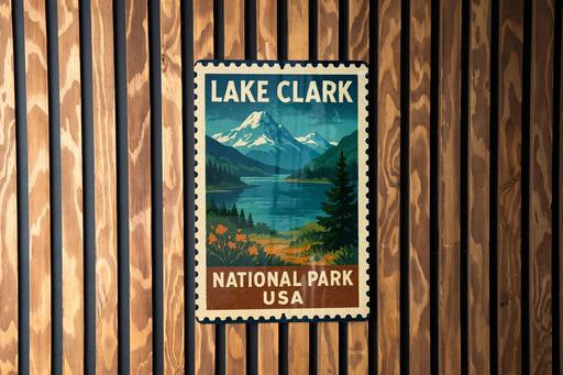 A vintage-style postage stamp featuring Lake Clark National Park in the USA, with a mountain landscape and a lake in the background.