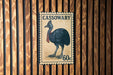 A postage stamp featuring a black bird, likely a cassowary, with the text "CASSOWARY 60c" printed on it.