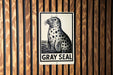 A sign featuring a black and white illustration of a seal, with the text "GRY SEAL" below it.