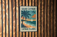 A vintage-style postage stamp from the Grand Cayman Islands, featuring a palm tree and a sailboat on the beach, mounted on a wooden wall.