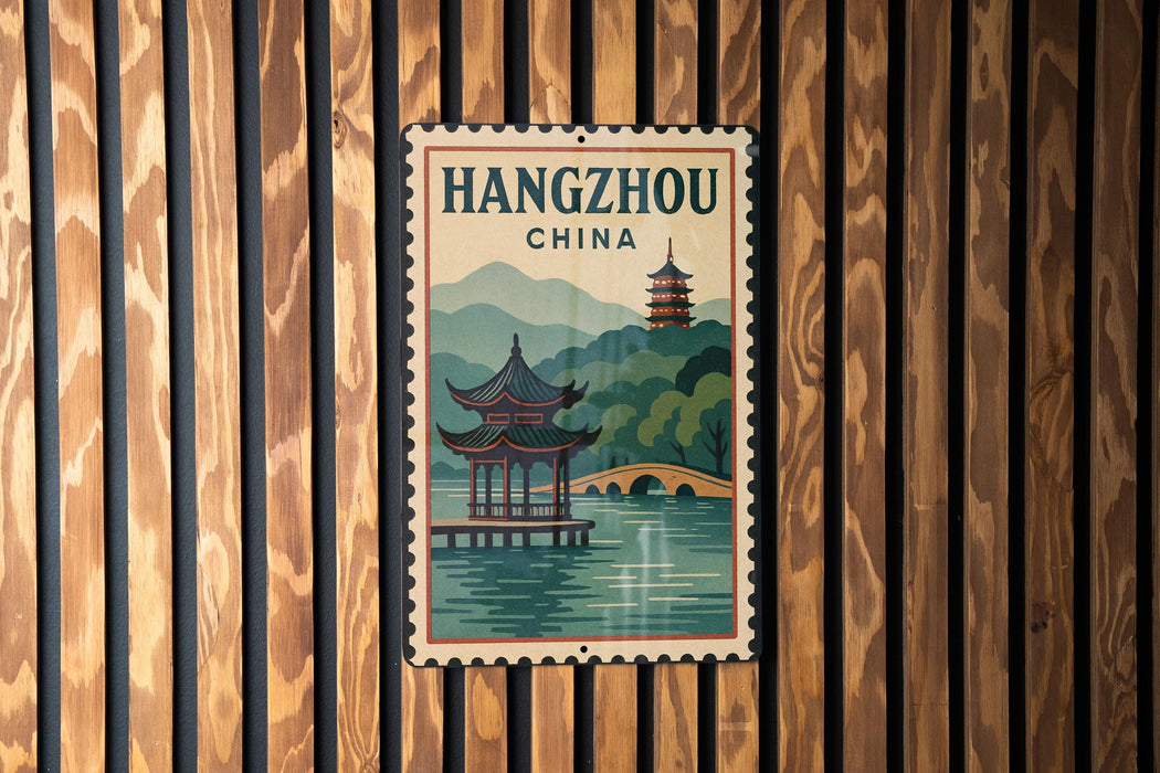 A vintage-style poster of Hangzhou, China, featuring a pagoda and a river, is displayed on a wooden wall.