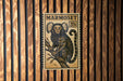 A poster of a monkey is displayed on a wooden wall.