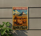 A vintage-style metal sign for the Petrified Forest National Park in the United States, featuring a landscape with a mountain and fallen tree trunks.