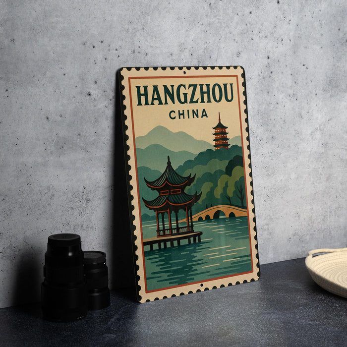 A vintage-style metal sign with a Chinese temple and mountains in the background, along with the text "Hangzhou China".