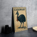 A metal sign featuring a black bird, likely a cassowary, with a stamp-like border and text.