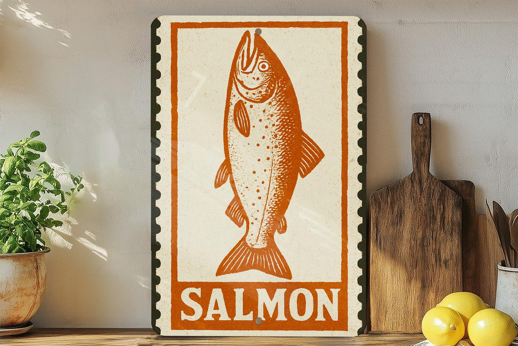 a framed illustration of a salmon fish, with the word "SALMON" written below it. The salmon is depicted in a stylized manner, with a prominent mouth and fins. The framed artwork is placed on a shelf, surrounded by various kitchen utensils and items, such as a wooden cutting board and a potted plant.