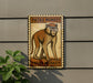 a sign with a monkey illustration, mounted on a wall next to a plant.