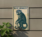 a blue monkey sitting on a wall.