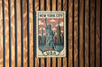 A vintage-style metal stamp featuring the Statue of Liberty in New York City, with the text "NEW YORK CITY USA" prominently displayed.