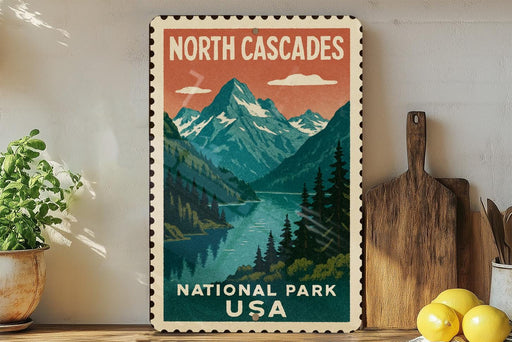 A vintage-style postage stamp depicting a scenic mountain landscape with a lake, surrounded by pine trees and mountains, is displayed on a wall next to a wooden cutting board and some potted plants.