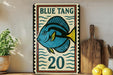 A vintage-style sign featuring a blue fish with the number 20, placed on a wooden surface next to a wooden cutting board and some lemons.