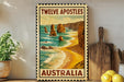 A framed poster of the Twelve Apostles, a famous rock formation in Australia, is displayed on a wall next to a wooden cutting board and a potted plant.