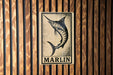 a sign with the word "MARLIN" on it, which is displayed on a wooden wall.