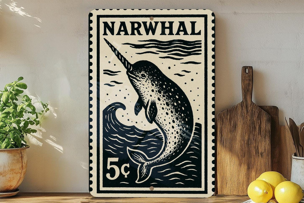 A black and white poster of a narwhal, a type of whale, is displayed on a wall next to a wooden cutting board and some lemons.