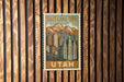 A vintage-style postage stamp depicting Salt Lake City, Utah, with a mountain range in the background.