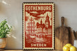A vintage-style metal sign with a red and white design depicting a sailing ship and a city skyline, mounted on a wall next to a wooden cutting board and some potted plants.