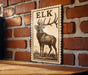 a wooden table with a framed print of a deer standing in a grassy field.