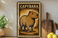 a metal sign with a picture of a capybara, a type of rodent, on it. The sign is placed on a shelf next to a wooden cutting board and some lemons.